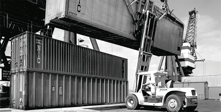 1950’s Hyster Company container handler lifting container.