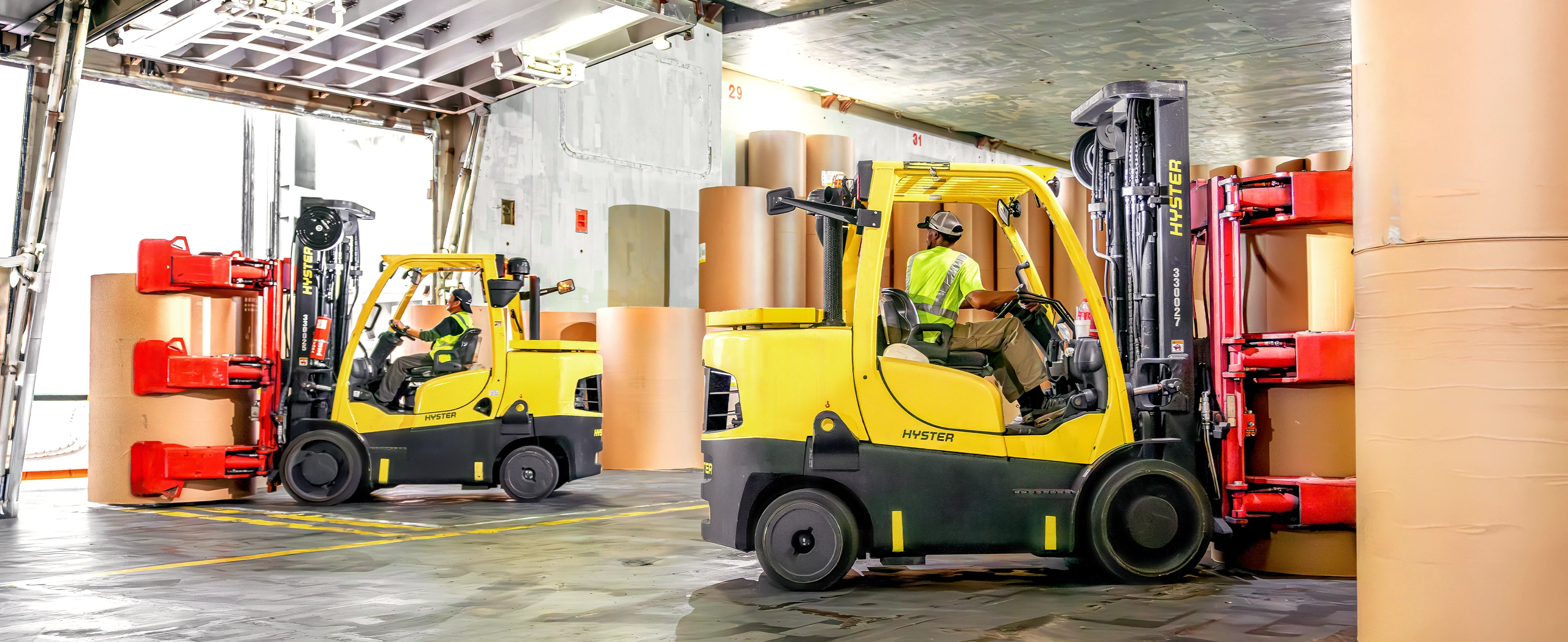 Hyster forklifts with Bolzoni paper clamps.