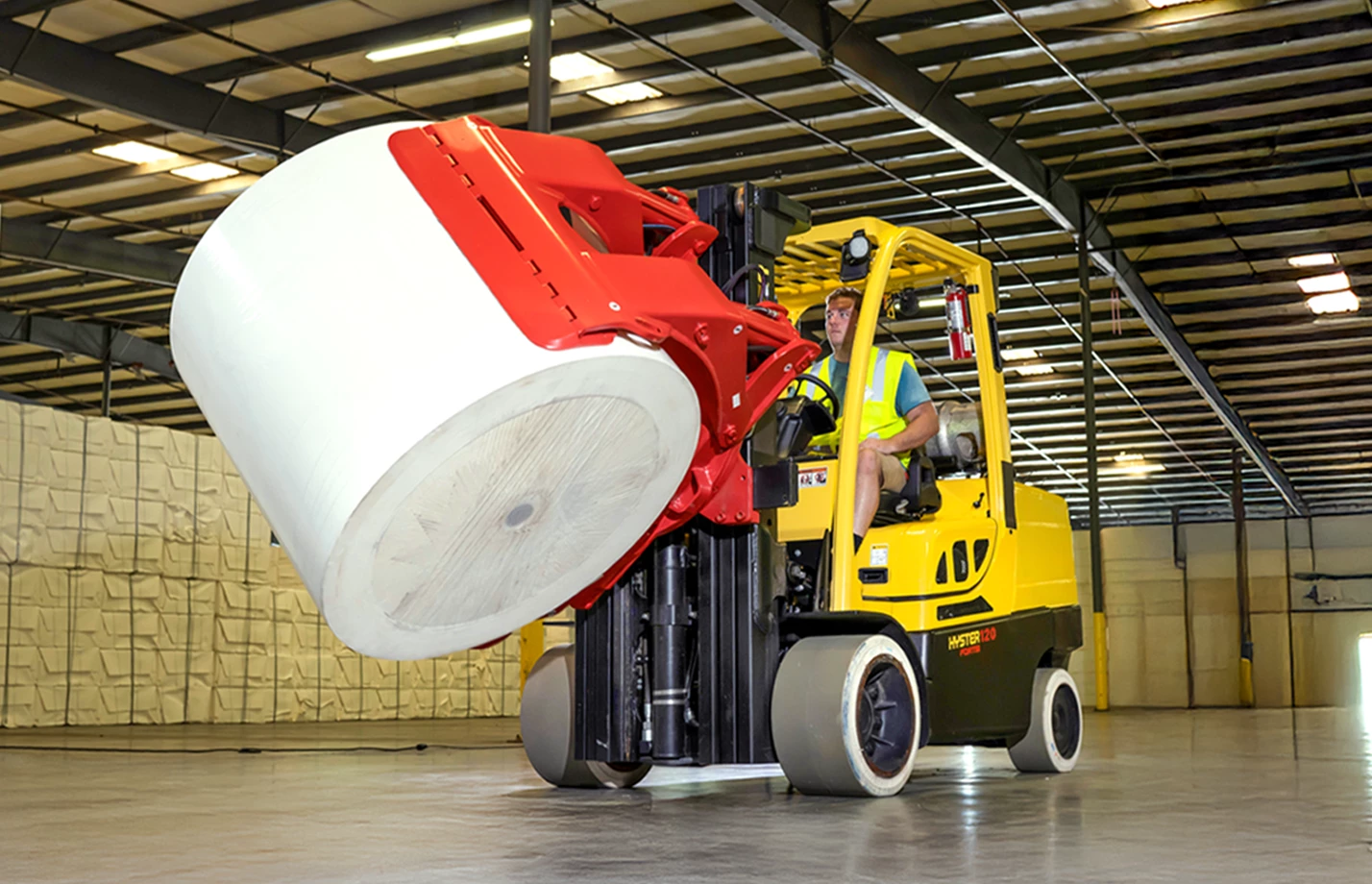 Auramo paper roll clamp on Hyster forklift.